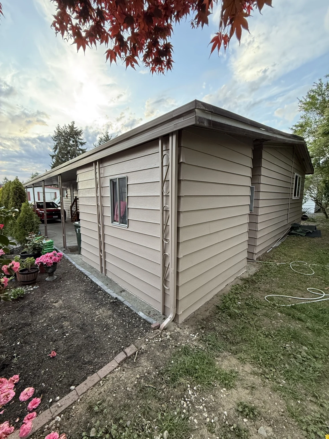 Painted exterior lap siding with corner trim and roofline detail