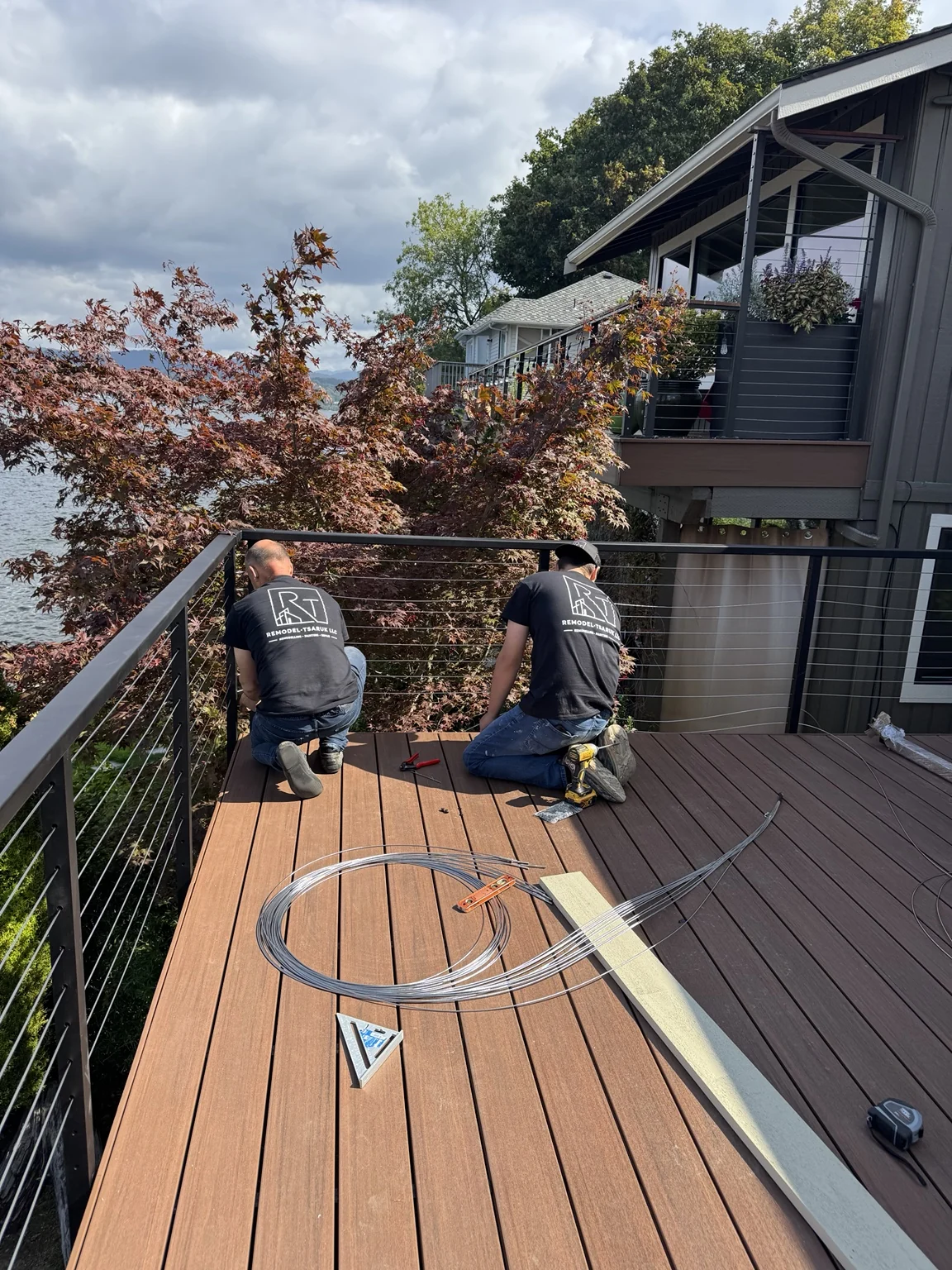 Remodel Tsaruk LLC crew installing cable railing on a residential deck