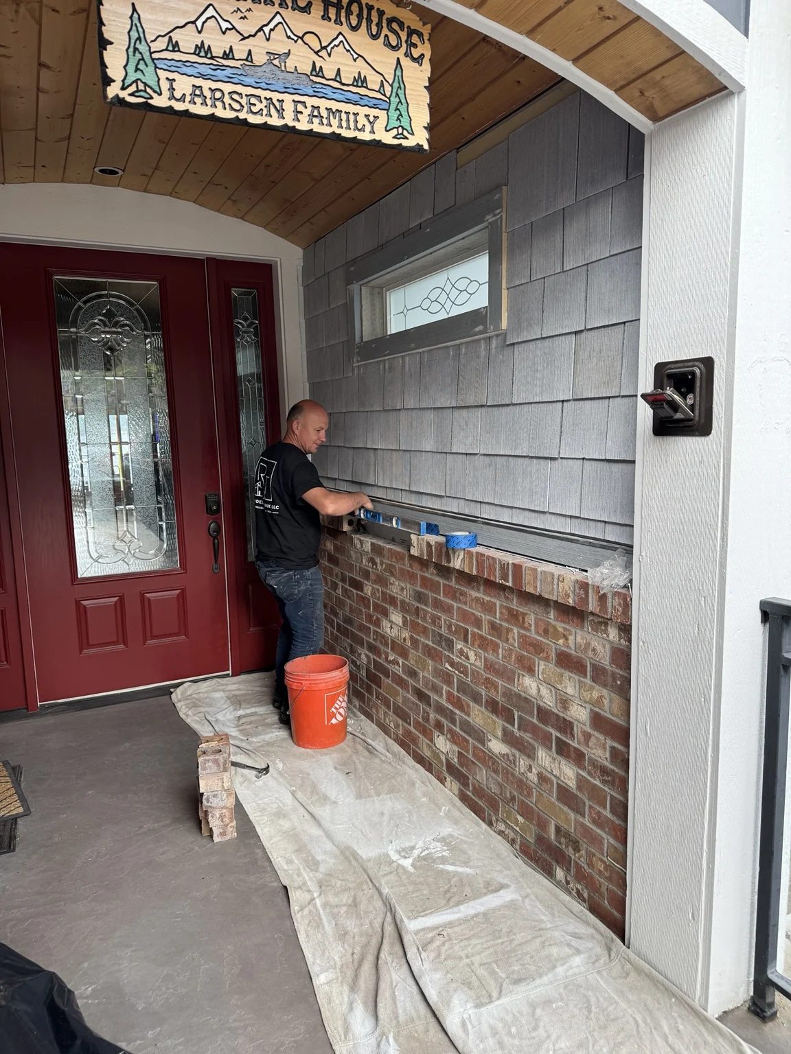 Remodel Tsaruk LLC team completing exterior repair and finish work at a home