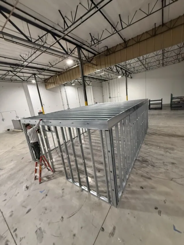 Metal stud wall framing and overhead framing inside a commercial space