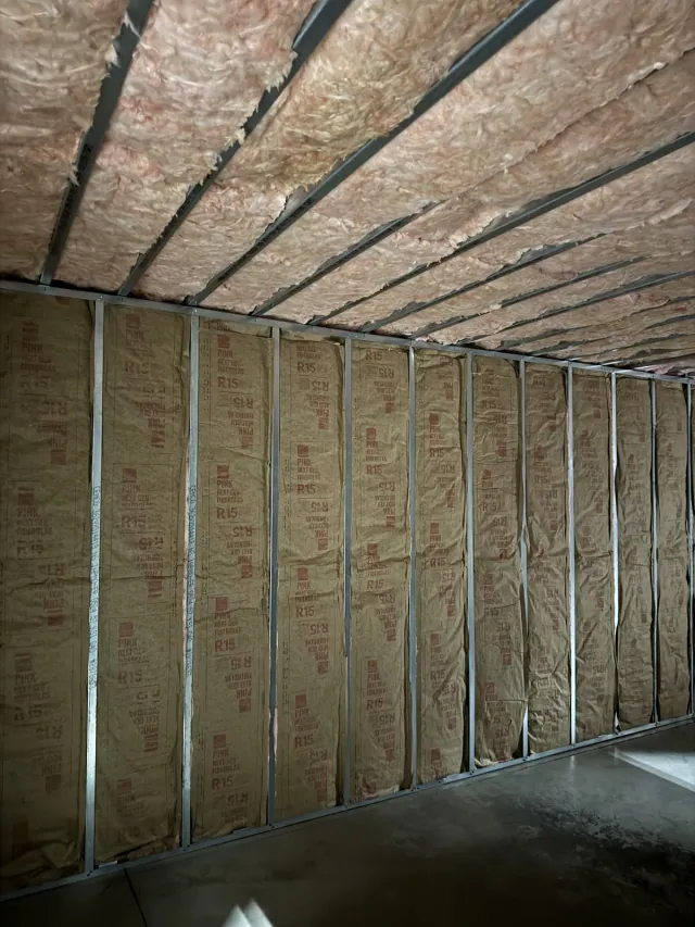 Insulated wall cavities and overhead framing viewed from inside