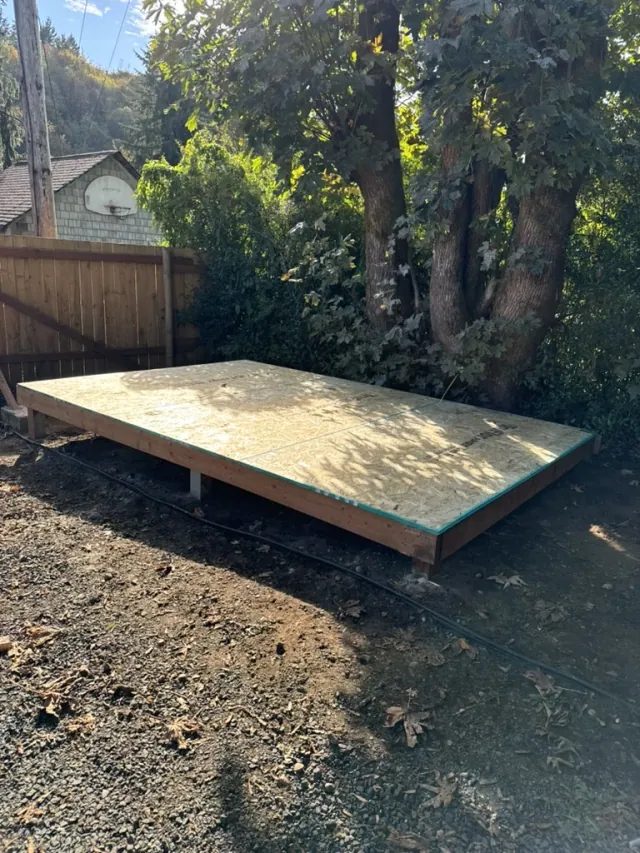 Raised wood floor platform with sheet decking before shed wall framing