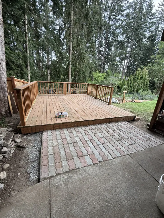 Overview of the custom wood deck beside an existing paved patio