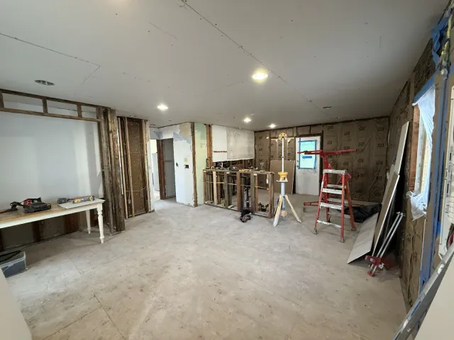 Interior preparation with exposed wall framing and ceiling drywall
