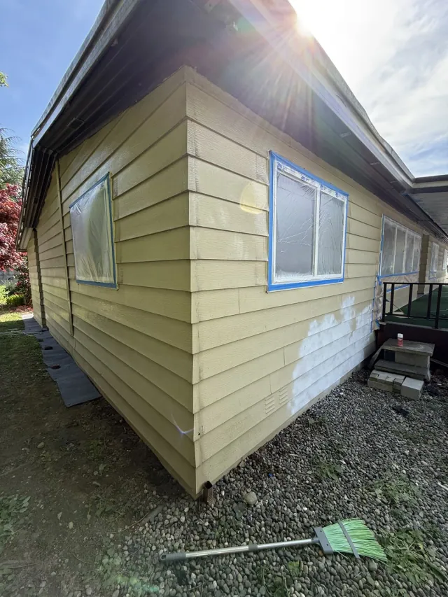 Masked windows and areas of surface preparation on the siding