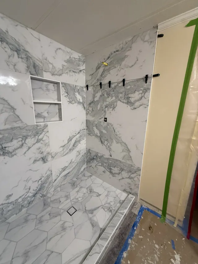Shower tile installation with leveling clips still in place