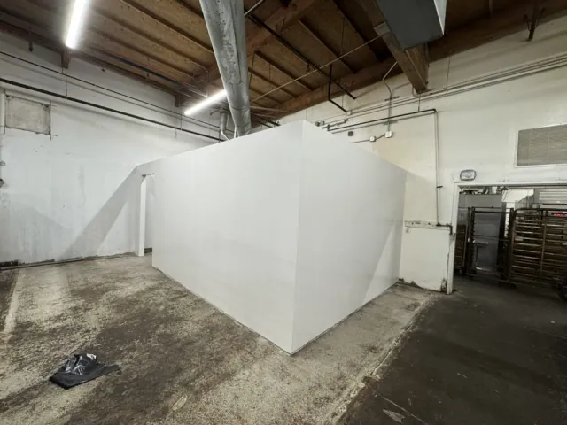 Finished white partition surfaces and an open doorway