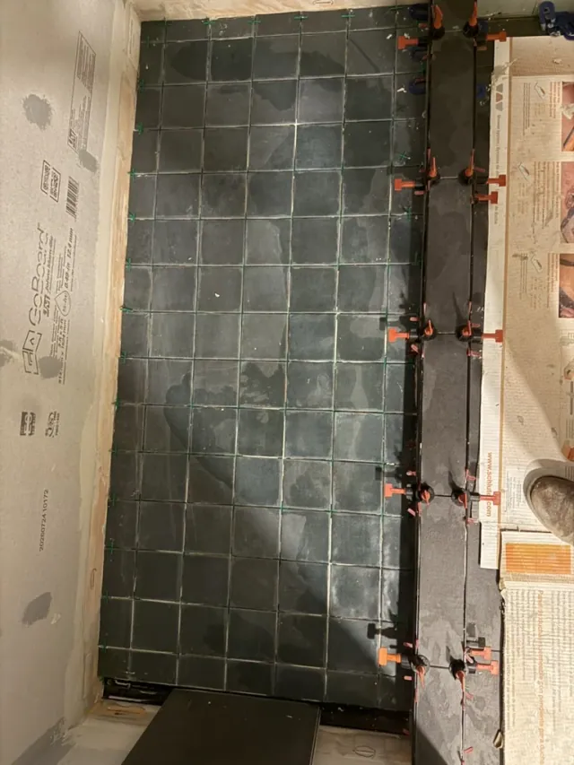 Dark bathroom floor tile installation by Remodel Tsaruk LLC